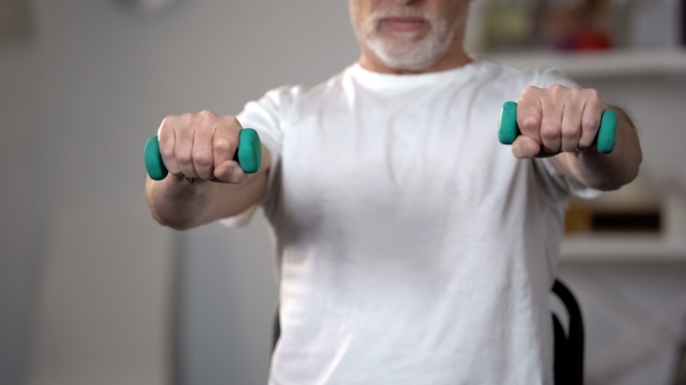 An older patient working out using weights.